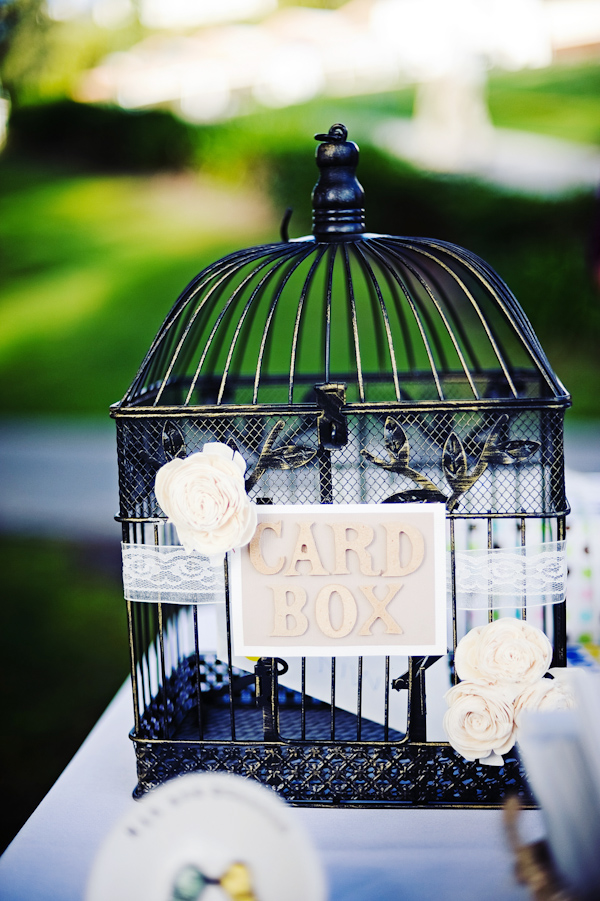 Birdcage decorated with white lace and light pink roses and used as a wedding card box - photo by San Francisco based wedding photographer Meg Perotti